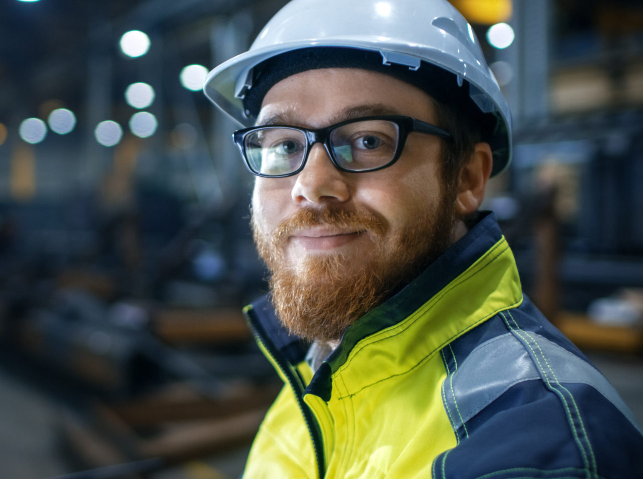 Man with safety gear smiling at camera